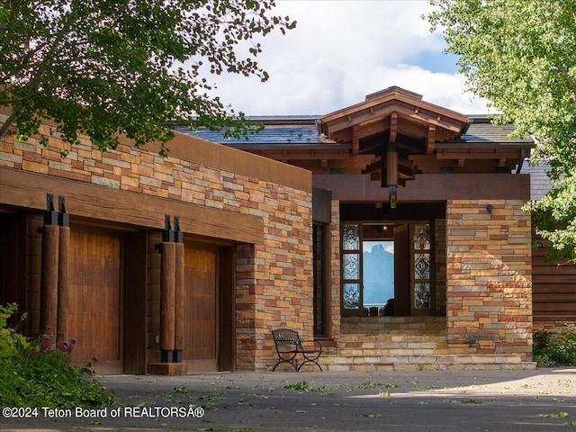 doorway to property with stone siding