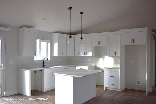 kitchen featuring decorative light fixtures, dark hardwood / wood-style flooring, white cabinetry, and a kitchen island