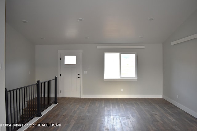 foyer entrance featuring dark hardwood / wood-style flooring and lofted ceiling