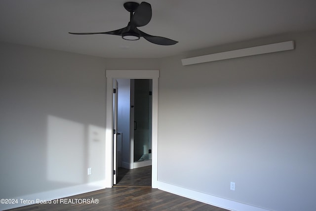 spare room featuring dark hardwood / wood-style floors and ceiling fan