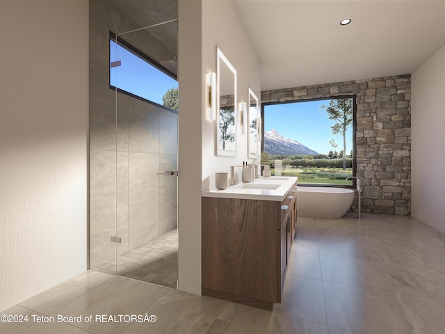 bathroom with a wealth of natural light, vanity, independent shower and bath, and tile patterned floors