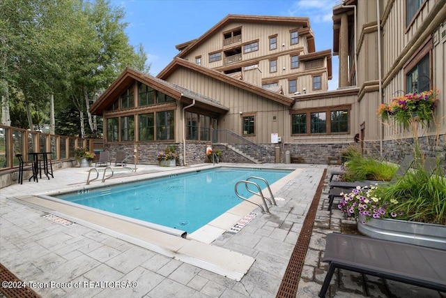 view of swimming pool with a patio