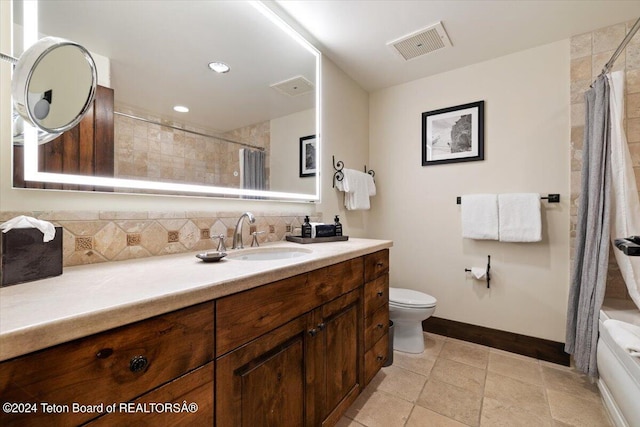 full bathroom with tile patterned flooring, backsplash, toilet, shower / tub combo, and vanity