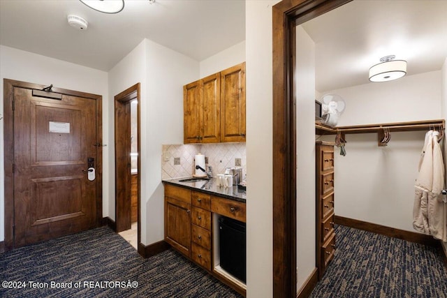 kitchen featuring tasteful backsplash and sink