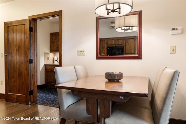 dining room with dark wood-type flooring