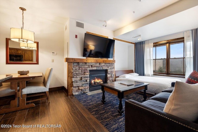 living room featuring a fireplace and dark hardwood / wood-style floors