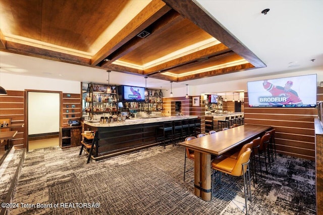 bar with carpet flooring, pendant lighting, a raised ceiling, and wooden ceiling