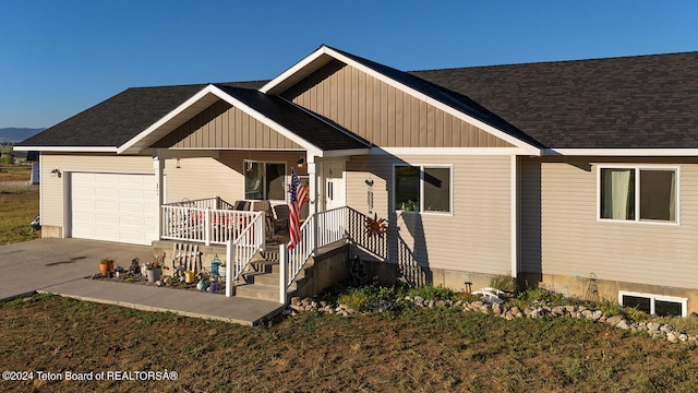 view of front of property featuring a garage and a porch