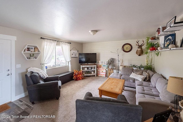 carpeted living area with baseboards