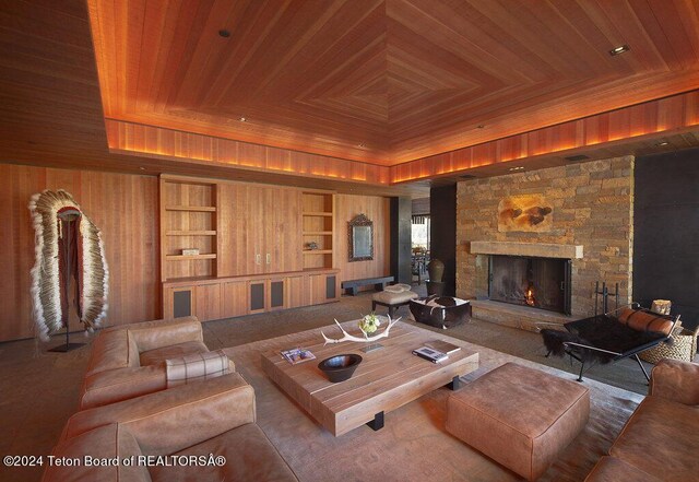 1605 N Amangani Dr, Jackson, WY 83001 - living area with a raised ceiling, wood ceiling, a stone fireplace, and built in features