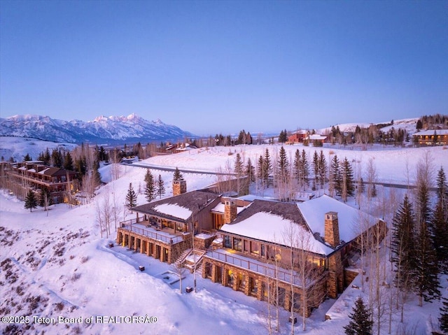 snowy aerial view featuring a mountain view