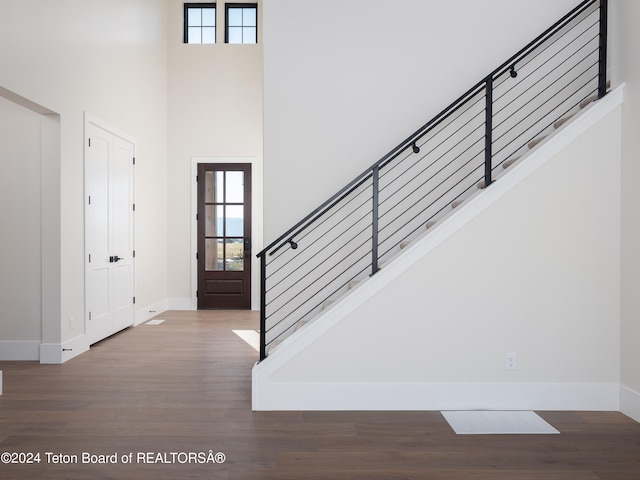 foyer featuring hardwood / wood-style flooring and a high ceiling