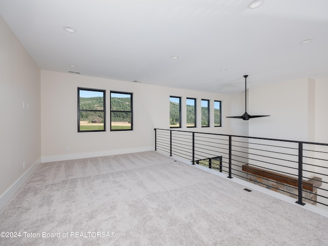 carpeted empty room with ceiling fan