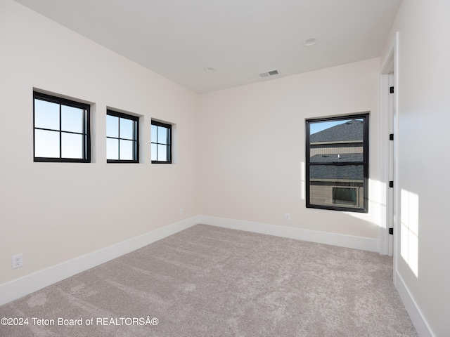 unfurnished room with light colored carpet