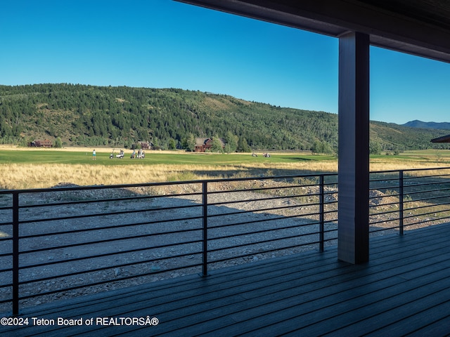 wooden deck featuring a mountain view and a rural view