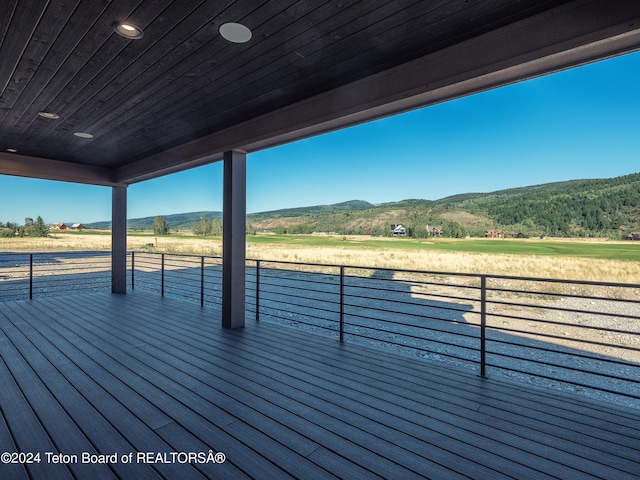 wooden deck with a mountain view and a rural view