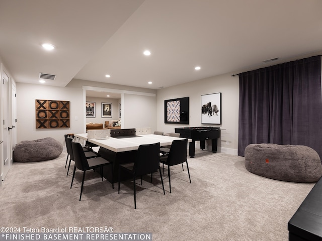 dining space featuring light carpet