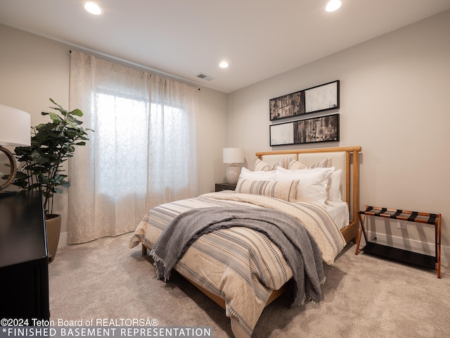 bedroom featuring light carpet