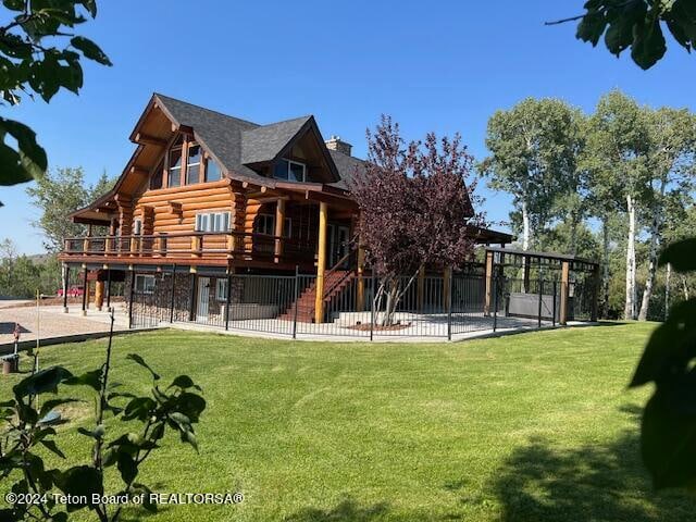 view of play area with a patio area, a wooden deck, and a lawn