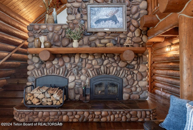 interior details featuring hardwood / wood-style flooring, a fireplace, wood ceiling, and log walls