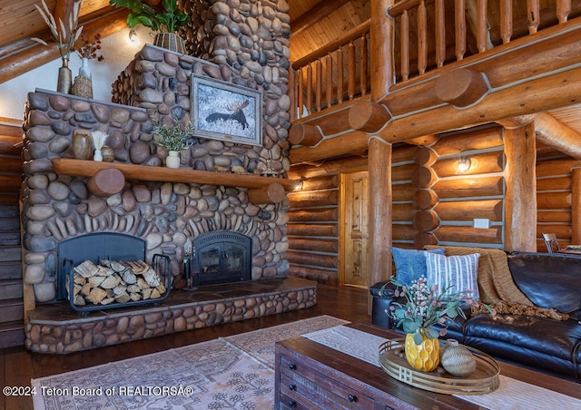 unfurnished living room featuring beamed ceiling, log walls, wood-type flooring, wooden ceiling, and a fireplace