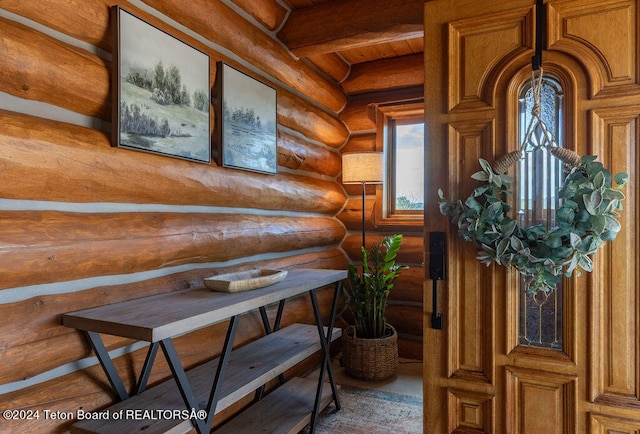 interior space with log walls and beam ceiling