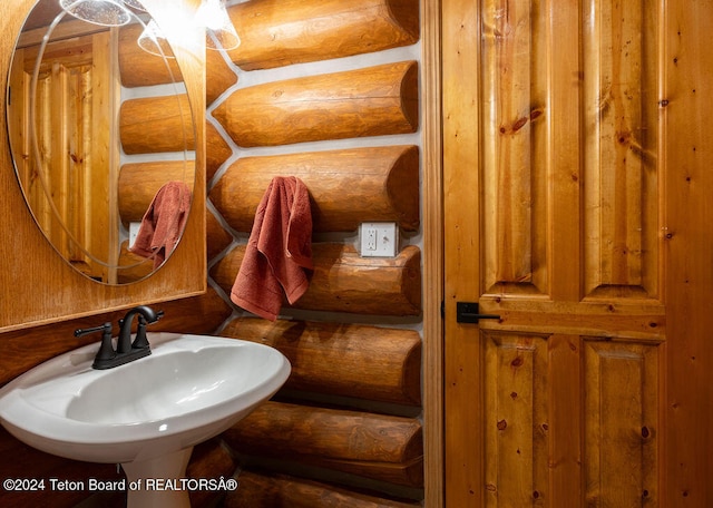 bathroom with log walls and sink