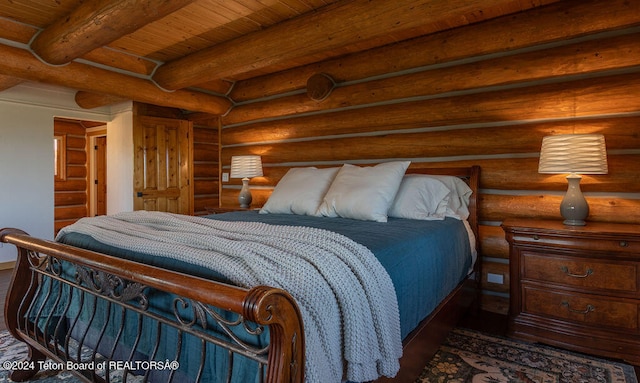 bedroom with beamed ceiling, wooden ceiling, and rustic walls