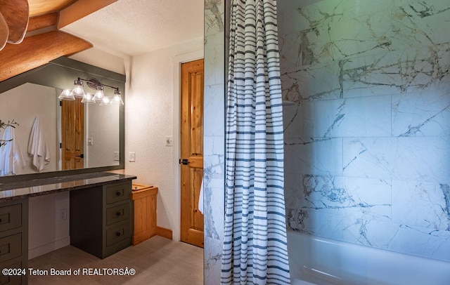 bathroom featuring vanity, a textured ceiling, shower / bathtub combination with curtain, and tile patterned floors