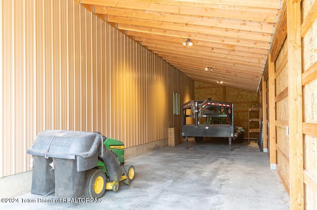 miscellaneous room with high vaulted ceiling and concrete flooring