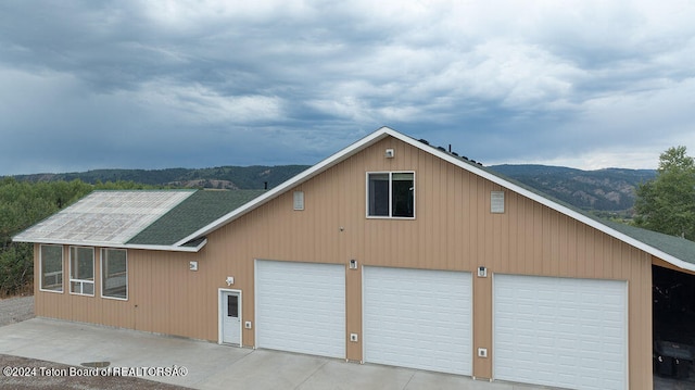 garage featuring a mountain view and wood walls