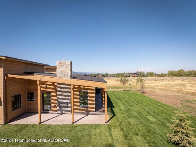 view of yard with a patio and a rural view