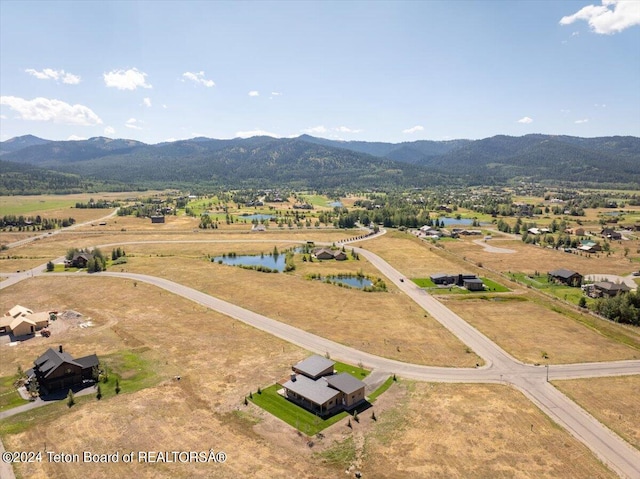 birds eye view of property featuring a rural view and a water and mountain view