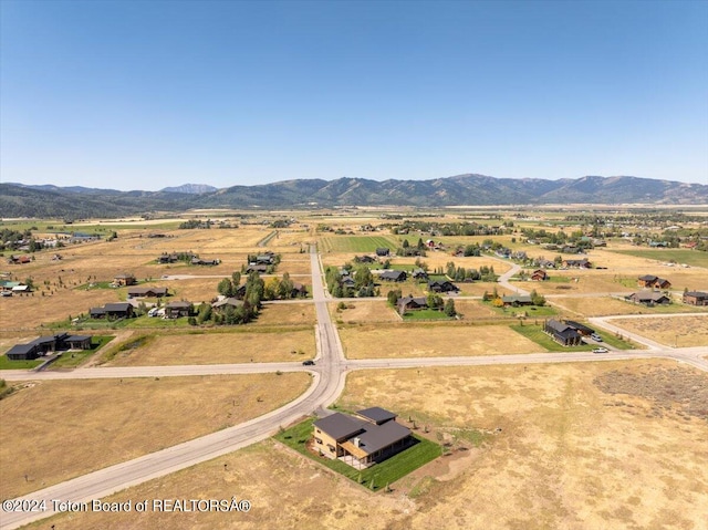 drone / aerial view featuring a mountain view and a rural view