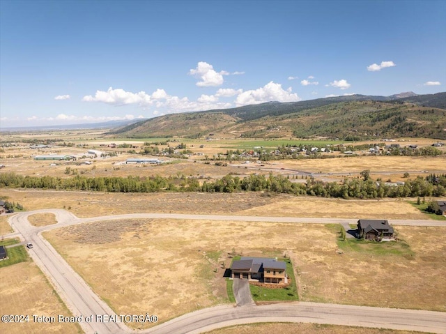 drone / aerial view featuring a mountain view and a rural view