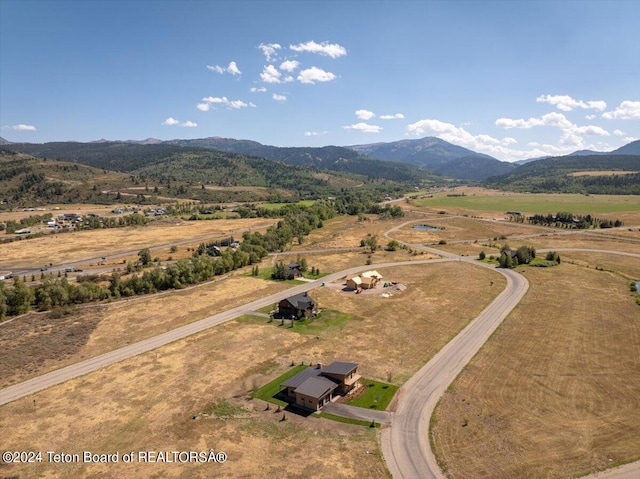 birds eye view of property with a mountain view and a rural view