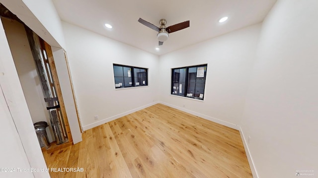 unfurnished room with hardwood / wood-style floors and ceiling fan