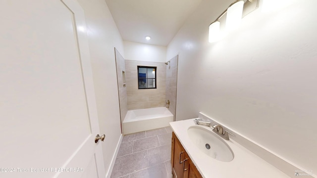 bathroom featuring vanity, tile patterned floors, and tiled shower / bath