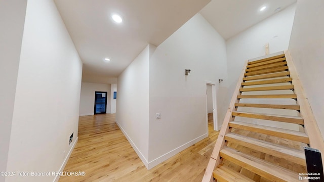 staircase with hardwood / wood-style flooring