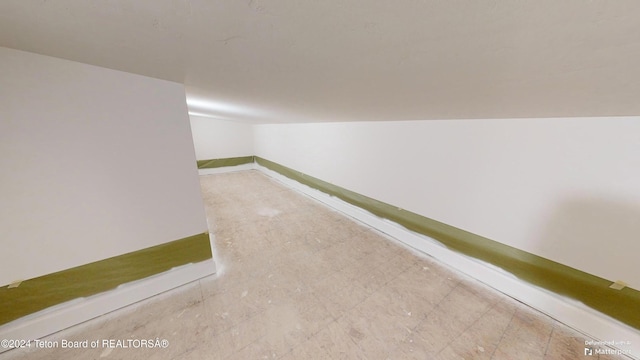 hallway with vaulted ceiling