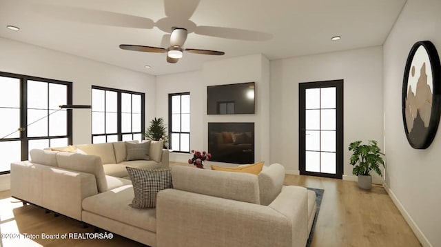 living room with ceiling fan and light hardwood / wood-style flooring