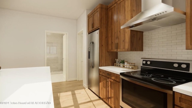 kitchen with wall chimney exhaust hood, backsplash, light hardwood / wood-style floors, electric stove, and high end fridge