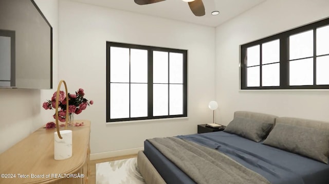 bedroom with ceiling fan and hardwood / wood-style floors