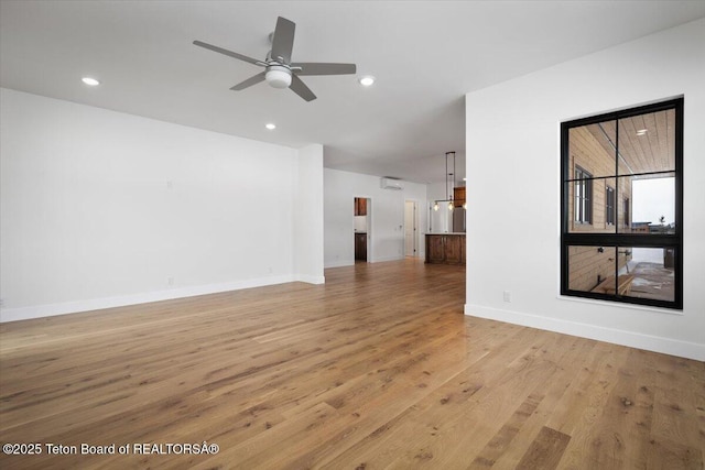 unfurnished living room featuring ceiling fan and light hardwood / wood-style flooring