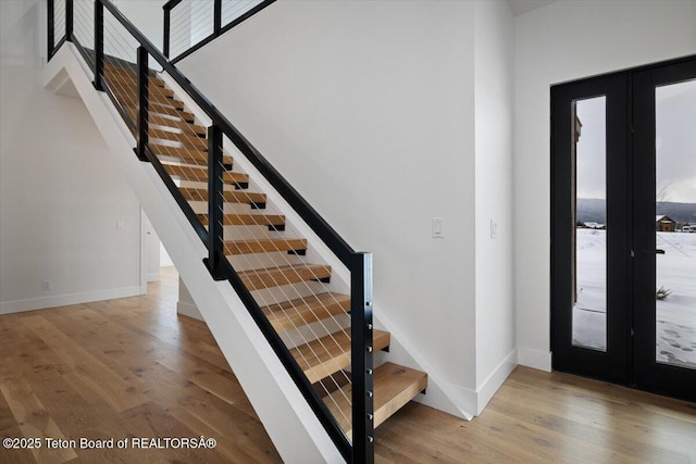 foyer with french doors and hardwood / wood-style flooring