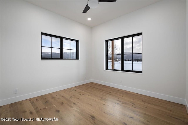 spare room with wood-type flooring and ceiling fan