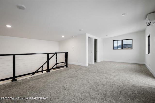 carpeted spare room with lofted ceiling and a wall mounted AC