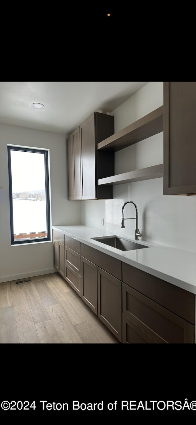 kitchen with light hardwood / wood-style flooring and sink