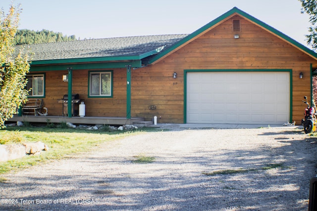 view of front facade with a garage and covered porch