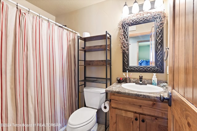 bathroom with walk in shower, vanity, toilet, and a textured ceiling